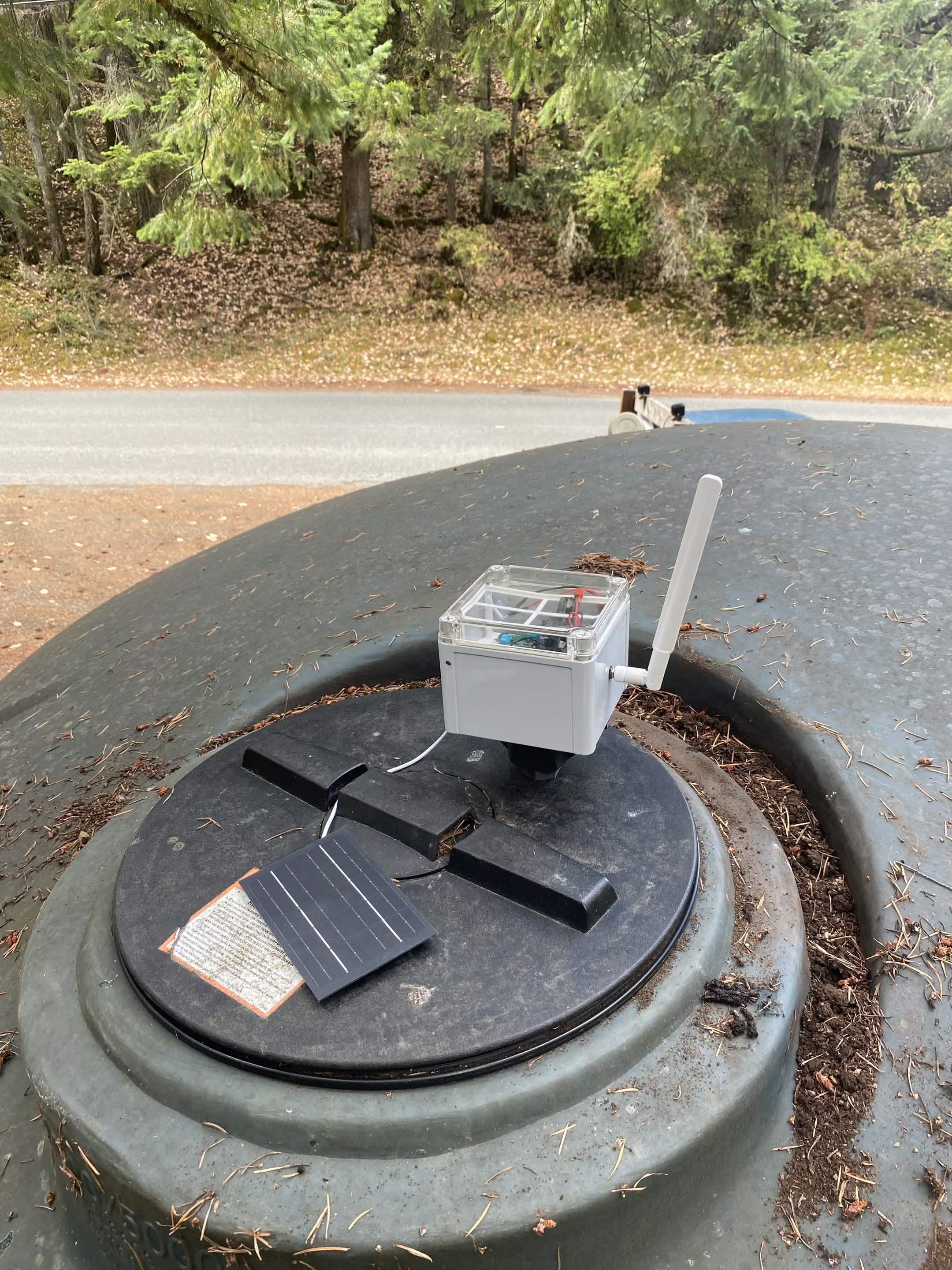 A MothNode monitoring unit mounted on a cistern lid, with its antenna and solar panel